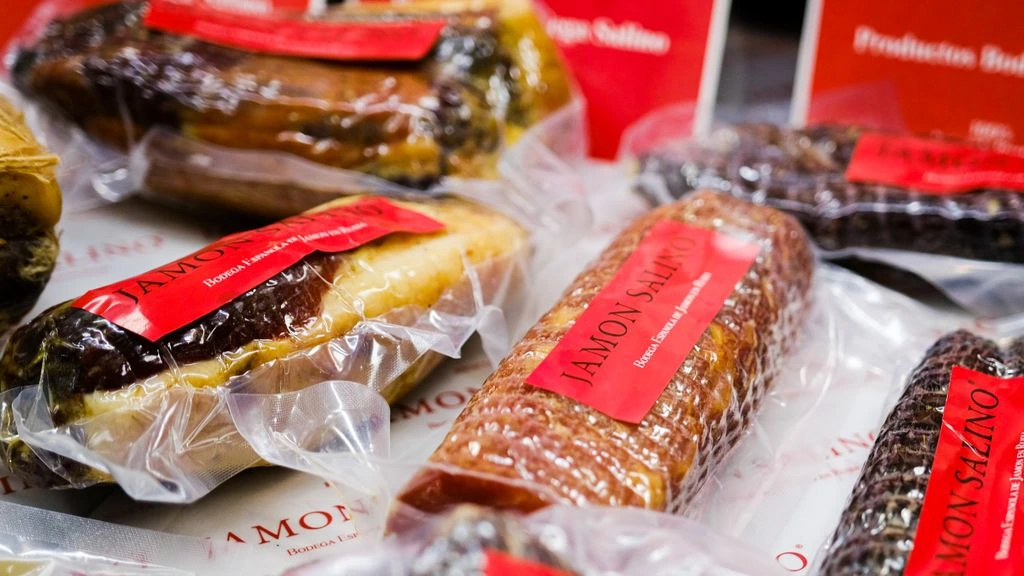 Packaged food jars with peeled label corner showing printing detail.